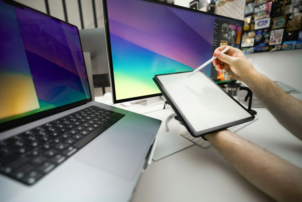 Lack of centralized HR system A person sitting at a desk with a laptop and a monitor