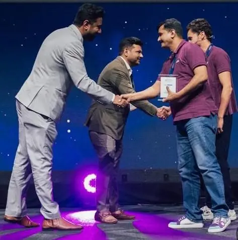 Award ceremony moment with professionals shaking hands on stage