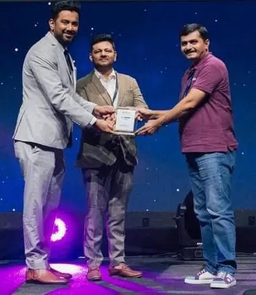 Professionals presenting and receiving an award trophy on stage